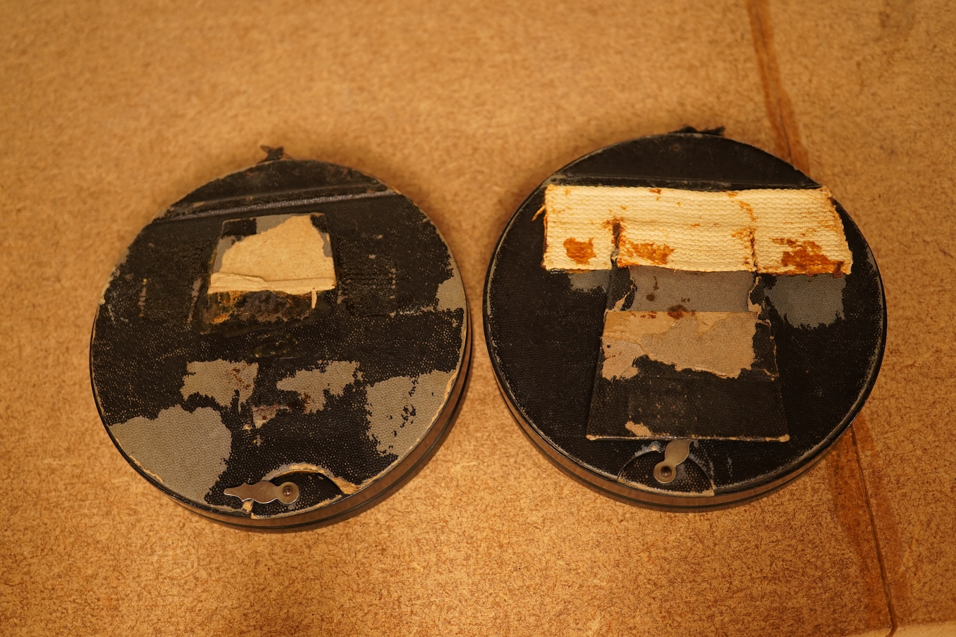 A pair of circular framed oval miniatures on porcelain plaques. Plaques 3.5cm high
